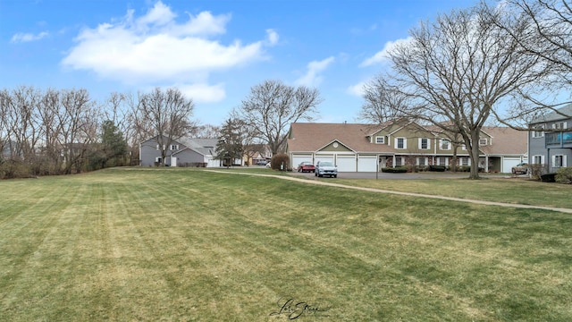 view of yard with a residential view and an attached garage