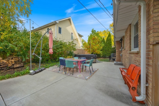 view of patio / terrace with a hot tub