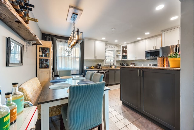 dining room featuring light tile patterned flooring and sink