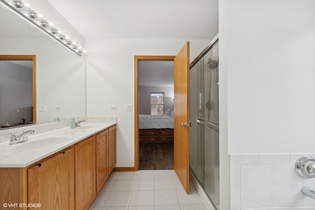 bathroom featuring tile patterned flooring, vanity, and walk in shower