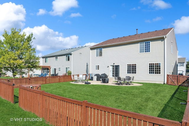 back of property with a patio, central AC, and a lawn