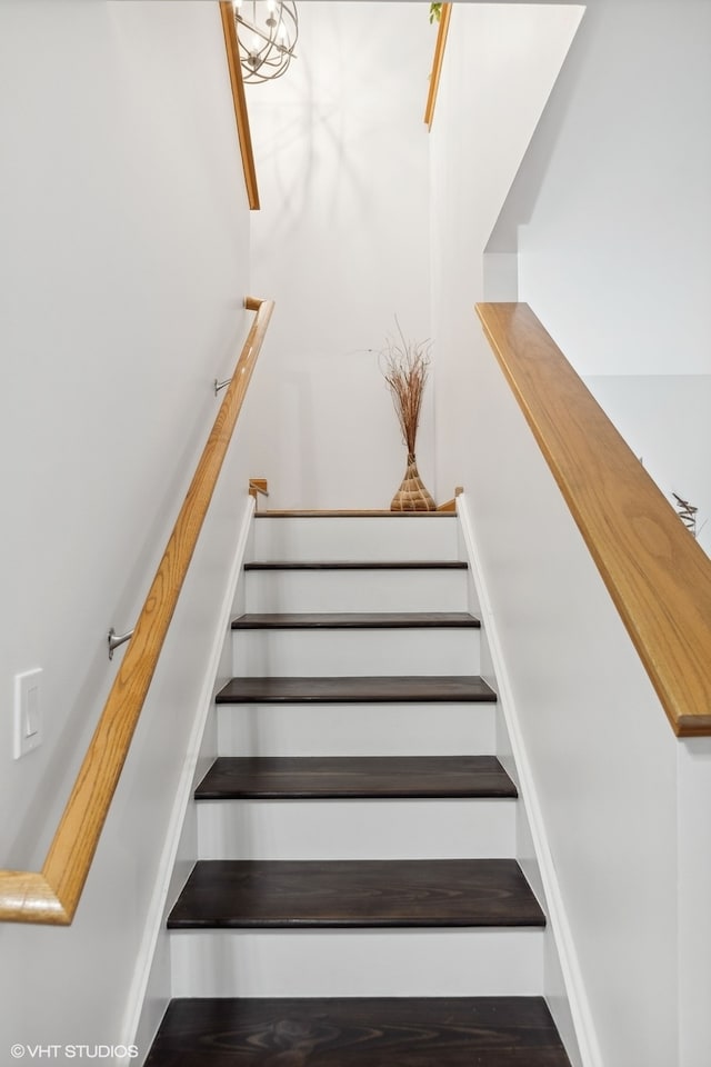 staircase with wood-type flooring