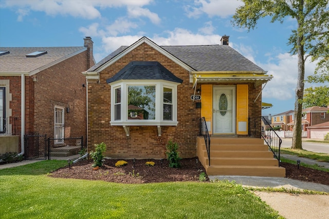 bungalow-style home featuring a front yard