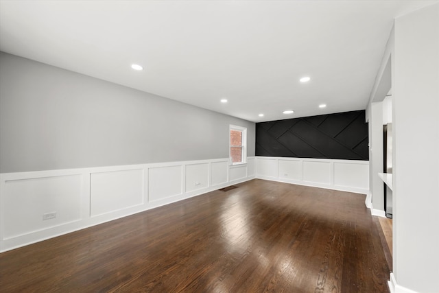 unfurnished room with dark wood-type flooring