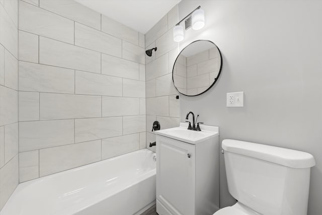 full bathroom with vanity, toilet, and tiled shower / bath