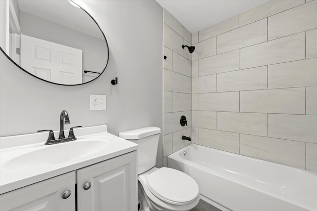 full bathroom with vanity, tiled shower / bath combo, and toilet