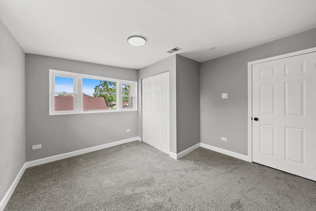 unfurnished bedroom featuring carpet flooring and a closet