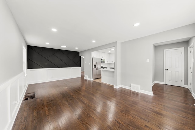 unfurnished living room with dark hardwood / wood-style floors