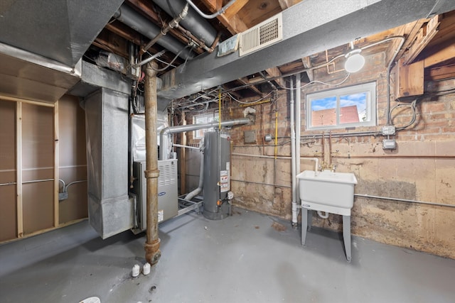 basement with sink, heating unit, and water heater