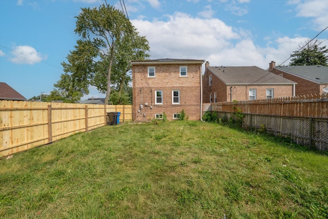 back of house featuring a lawn