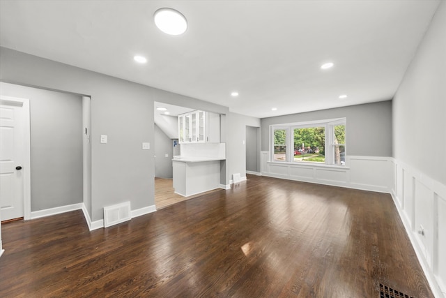 unfurnished living room with dark hardwood / wood-style floors