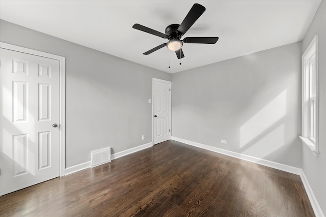 unfurnished room with dark hardwood / wood-style flooring and ceiling fan