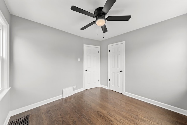 unfurnished bedroom featuring dark hardwood / wood-style floors and ceiling fan