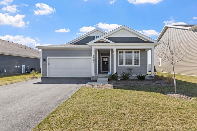 view of front of house with a front lawn and a garage