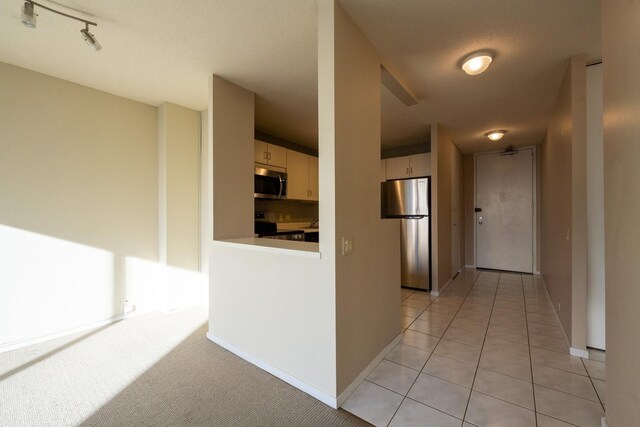 hall featuring light tile patterned floors