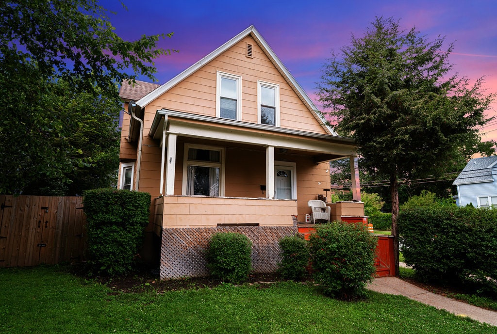 view of front of house with a porch and a yard