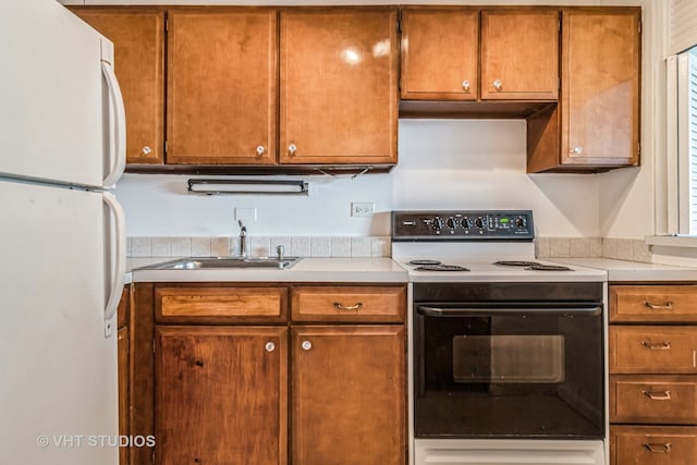 kitchen with white appliances and sink