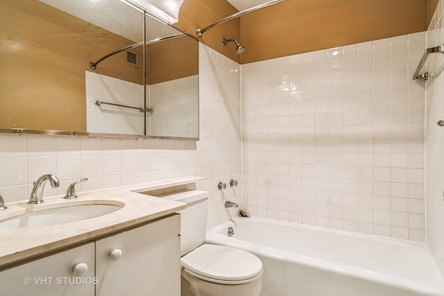 full bathroom with toilet, decorative backsplash, vanity, tile walls, and tiled shower / bath