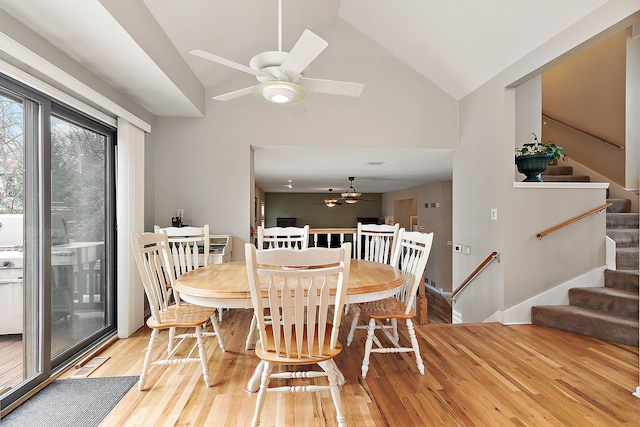 dining area featuring wood-type flooring, vaulted ceiling, and ceiling fan