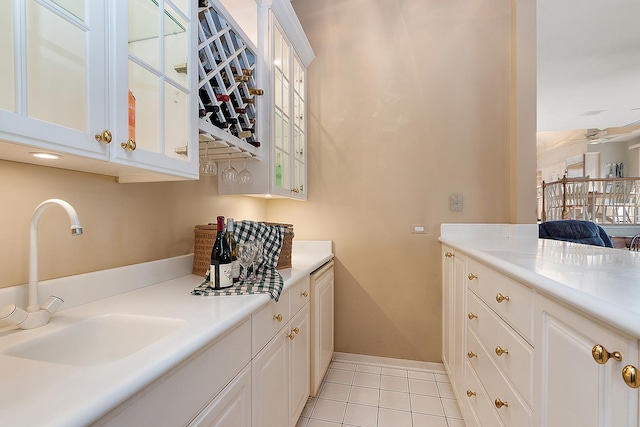 bathroom with tile patterned floors, ceiling fan, and sink