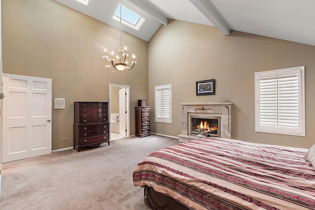 carpeted bedroom featuring beam ceiling, ensuite bathroom, high vaulted ceiling, and a skylight