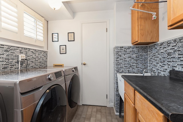 washroom with cabinets and washer and dryer