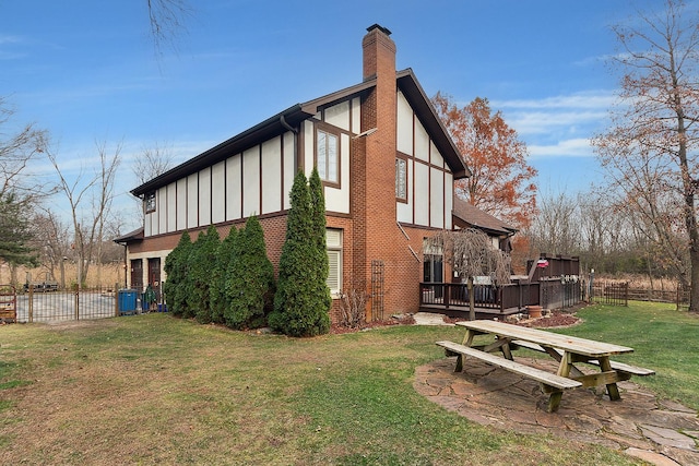 view of home's exterior featuring central AC, a wooden deck, and a lawn