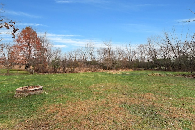 view of yard with a fire pit and a rural view