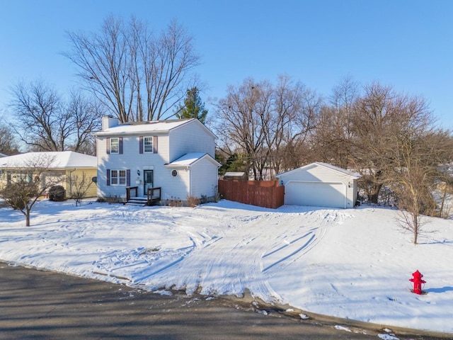 view of front facade featuring a garage and an outbuilding