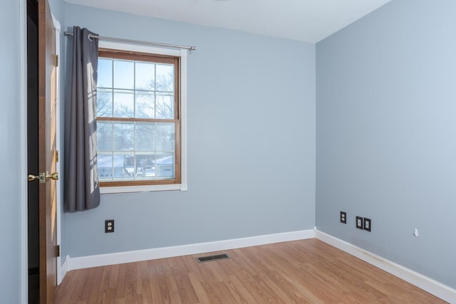 spare room featuring light hardwood / wood-style flooring