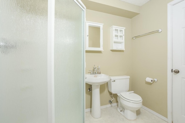 bathroom with toilet and a shower with shower door