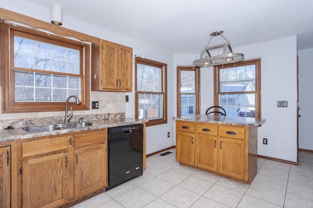 kitchen featuring decorative backsplash, light stone countertops, black dishwasher, and sink