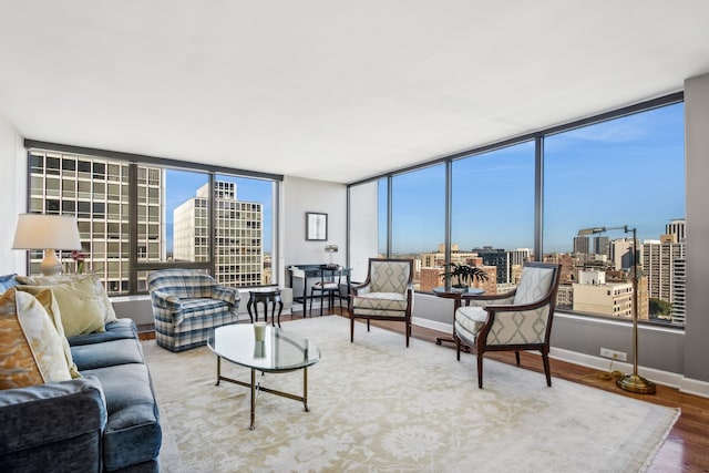 living room with hardwood / wood-style flooring and floor to ceiling windows