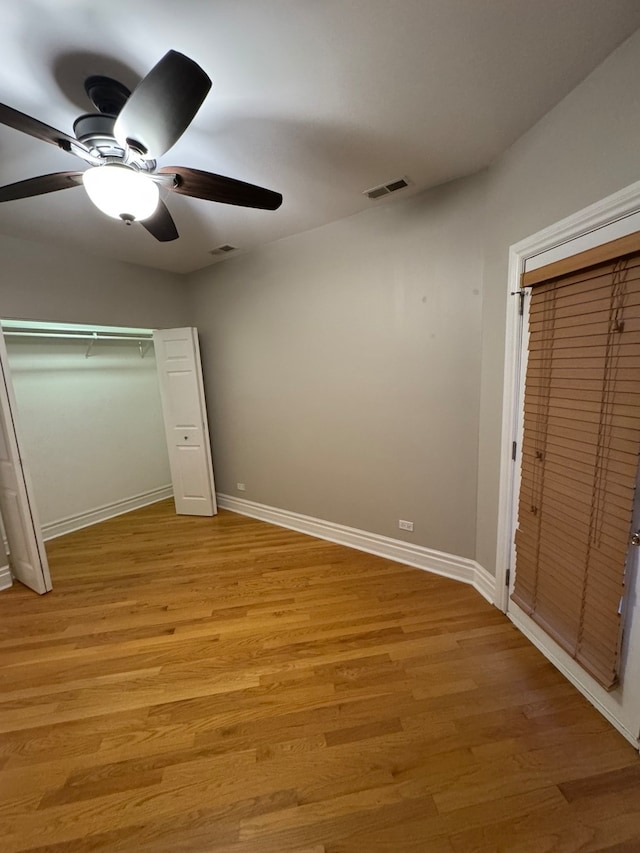 unfurnished bedroom with ceiling fan and light hardwood / wood-style floors