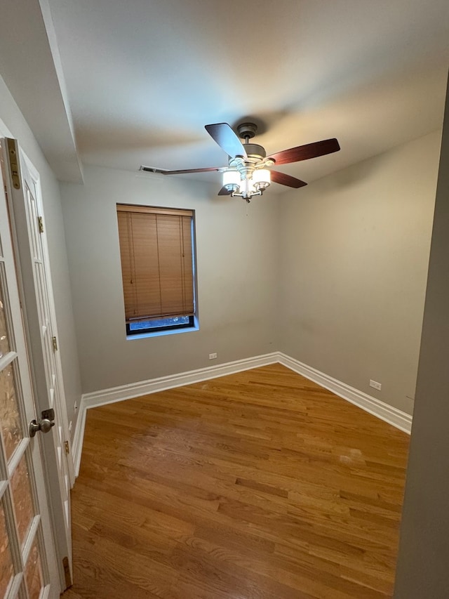 empty room featuring hardwood / wood-style flooring and ceiling fan