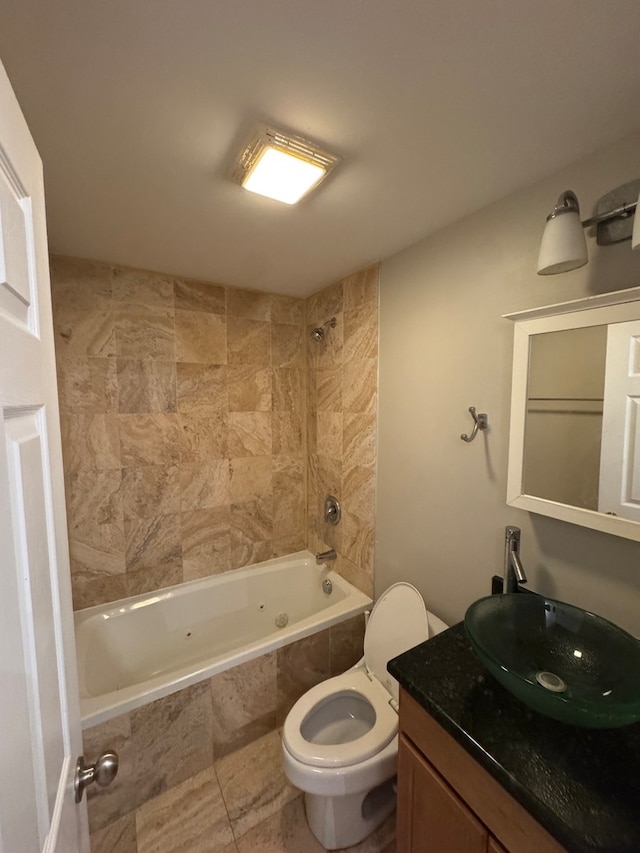 full bathroom featuring vanity, tile patterned floors, tiled shower / bath combo, and toilet