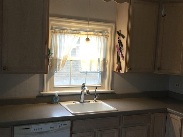 kitchen featuring decorative backsplash, dishwasher, and sink