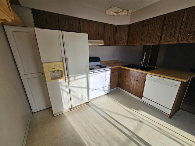 kitchen featuring dark brown cabinets, white appliances, extractor fan, and sink