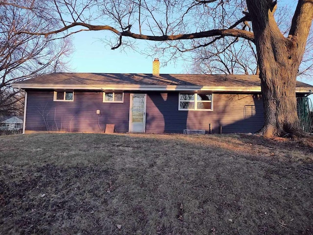 back of house with a lawn