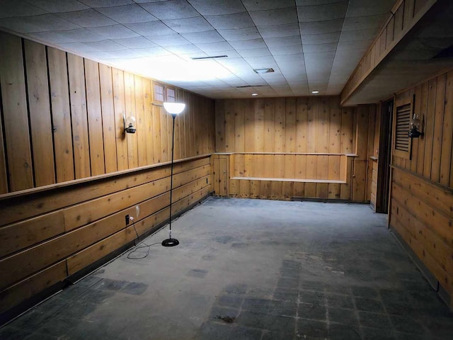 basement featuring wood walls