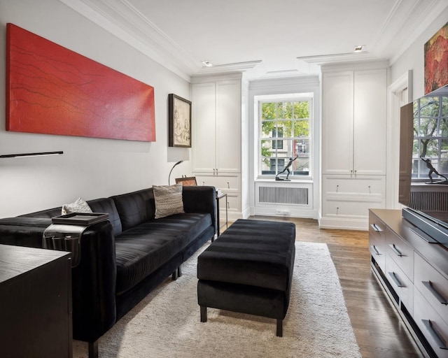 living room with radiator, crown molding, and wood-type flooring