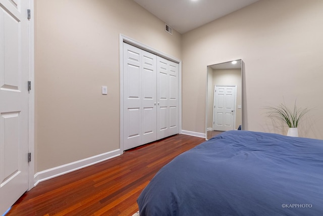 bedroom featuring a closet and dark wood-type flooring