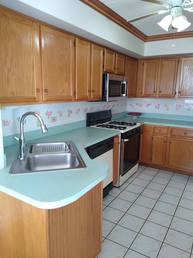 kitchen featuring white dishwasher, sink, gas stove, and kitchen peninsula