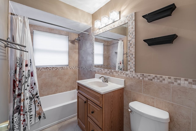 full bathroom featuring vanity, toilet, tile walls, and shower / tub combo