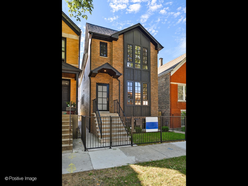 view of front of house with fence and brick siding