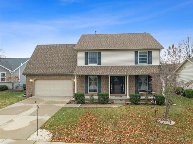 view of front property featuring a front yard, a porch, and a garage