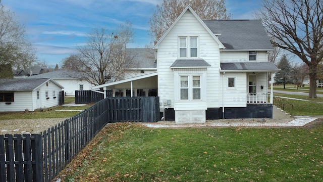 rear view of house with a lawn