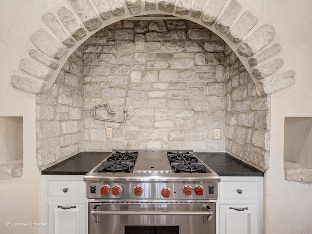 kitchen with white cabinetry and high end stove