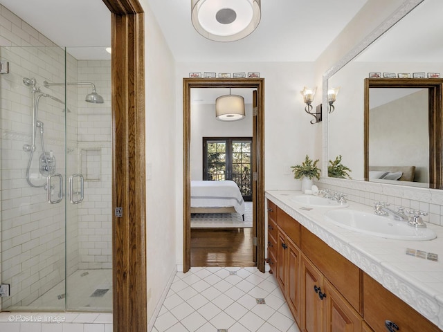 bathroom with a shower with door, tile patterned flooring, and vanity