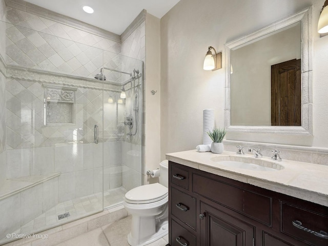 bathroom with toilet, tile patterned flooring, a shower with shower door, and vanity